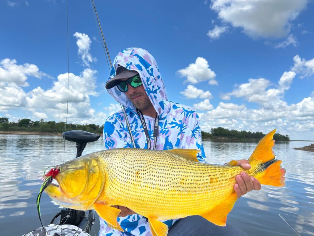 Person holding a large golden dorado at golden dorado lodge.