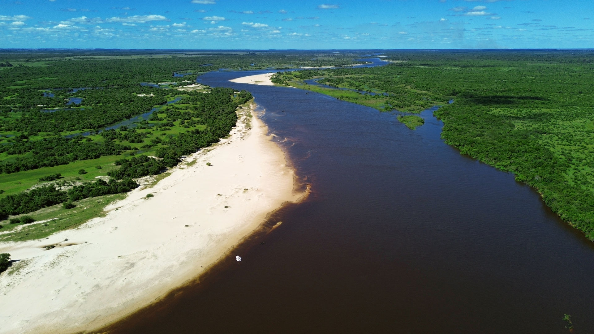 Aerial view of Parana River delta featuring sandy beaches and clear water