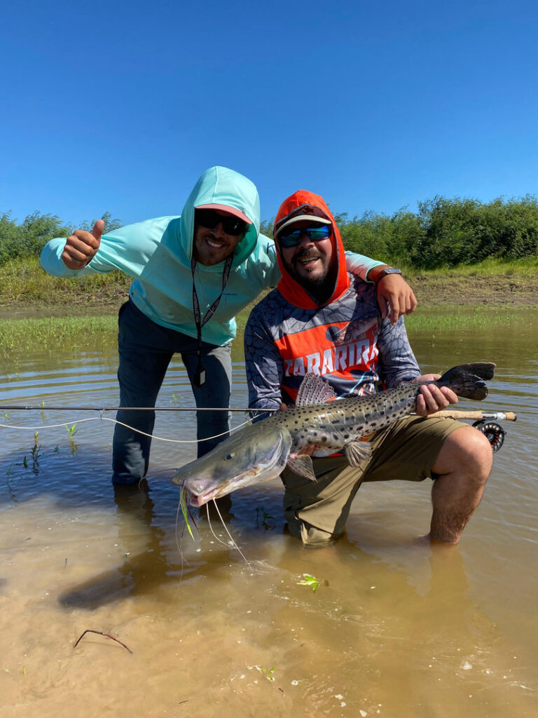 Angler casting for golden dorado in the Parana River wetlands