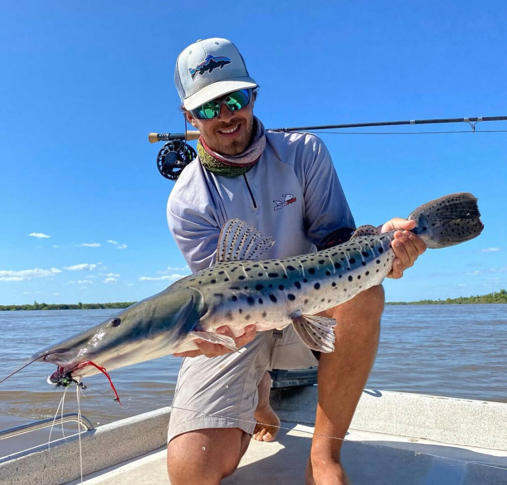 Angler holding large Surubi catfish catch at Golden Dorado Lodge