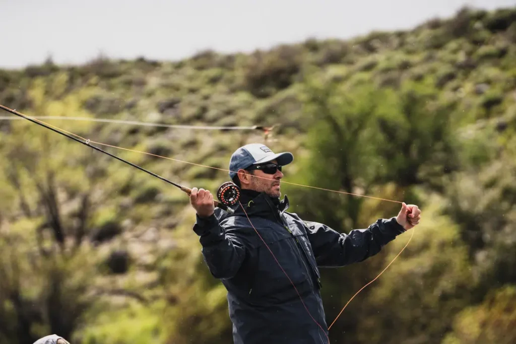 Sunroom with wicker chairs and view at Stone River Lodge