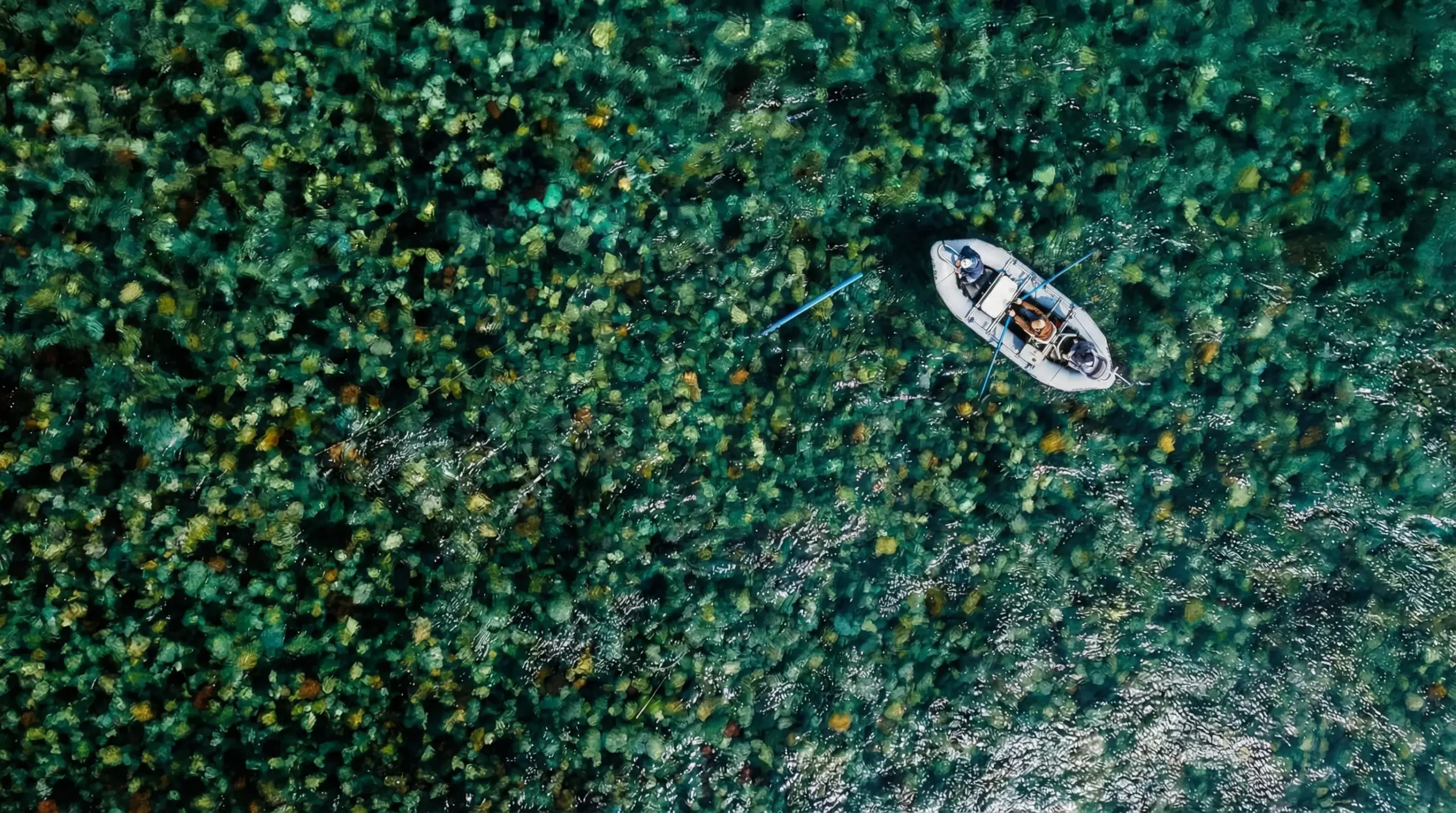 Aerial view of drift boat floating on clear Patagonia river