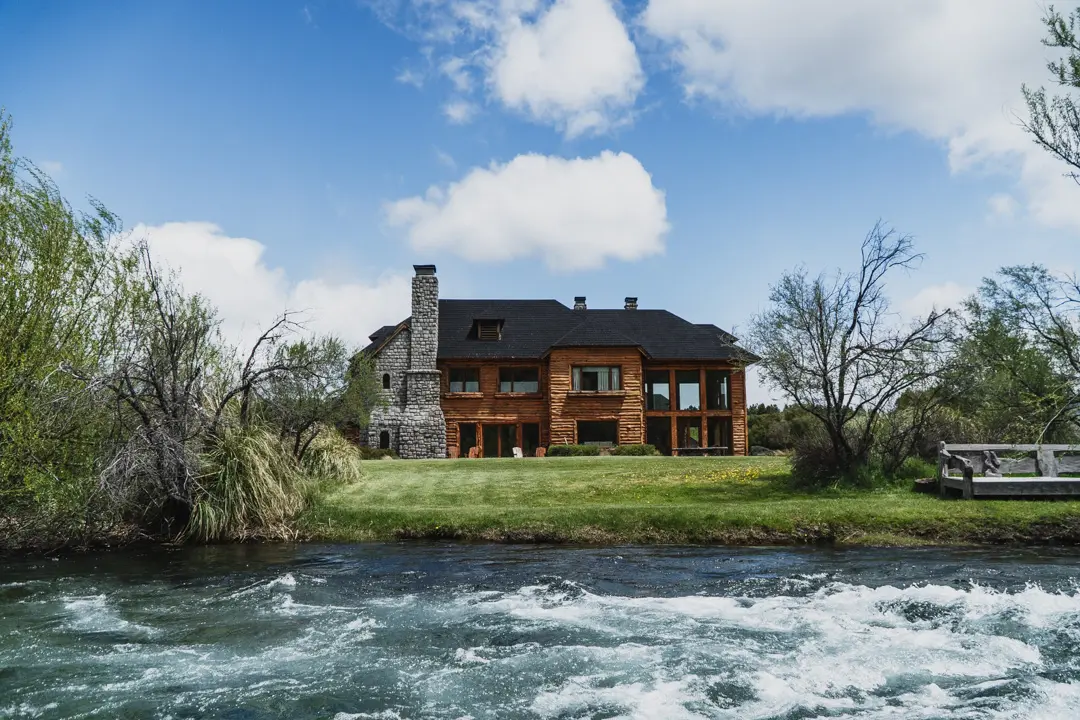 the perfect base for luxury patagonia trout fishing adventures. Riverside wooden lodge facing crystal-clear Patagonian waters,